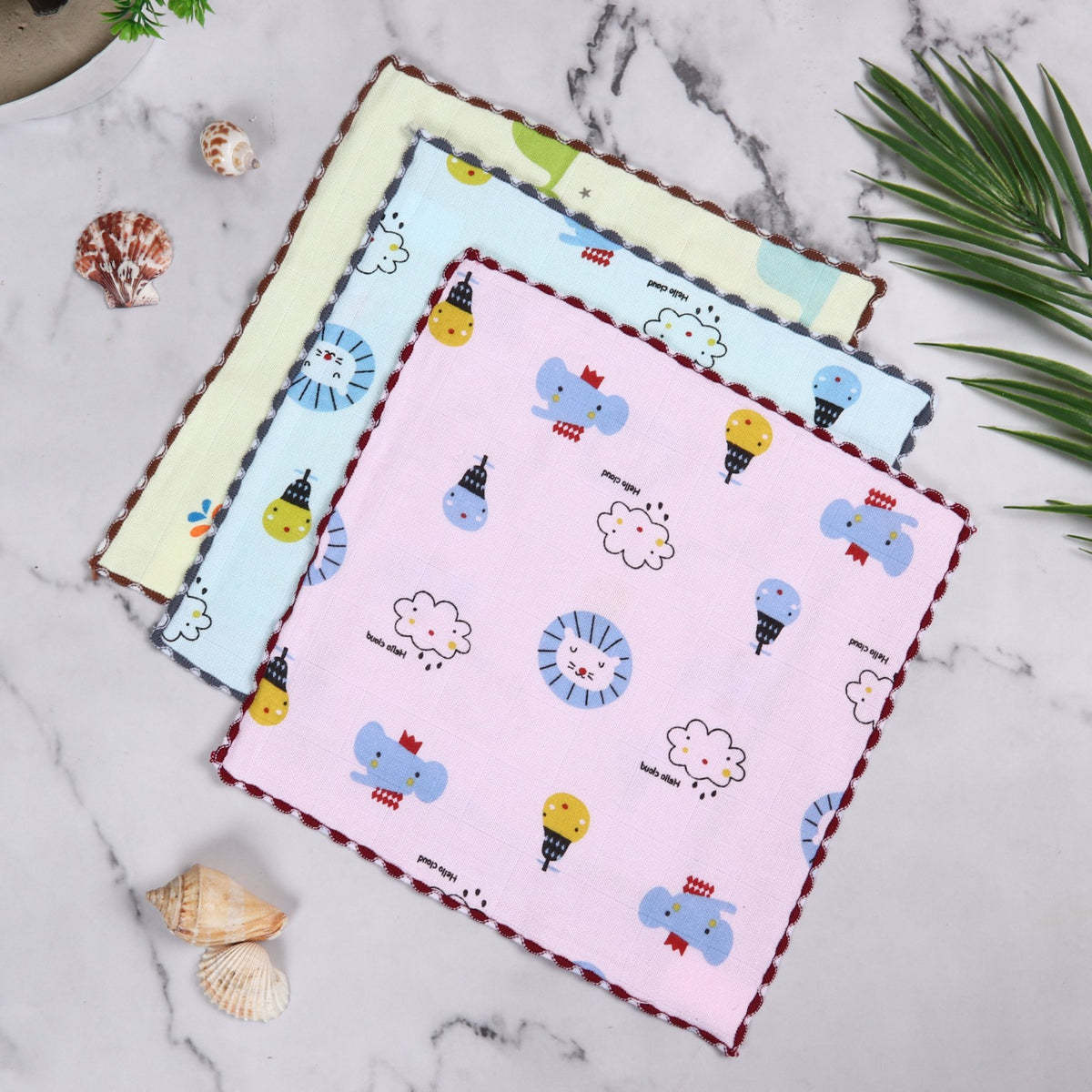Printed baby face towels showing pink blue and yellow designs